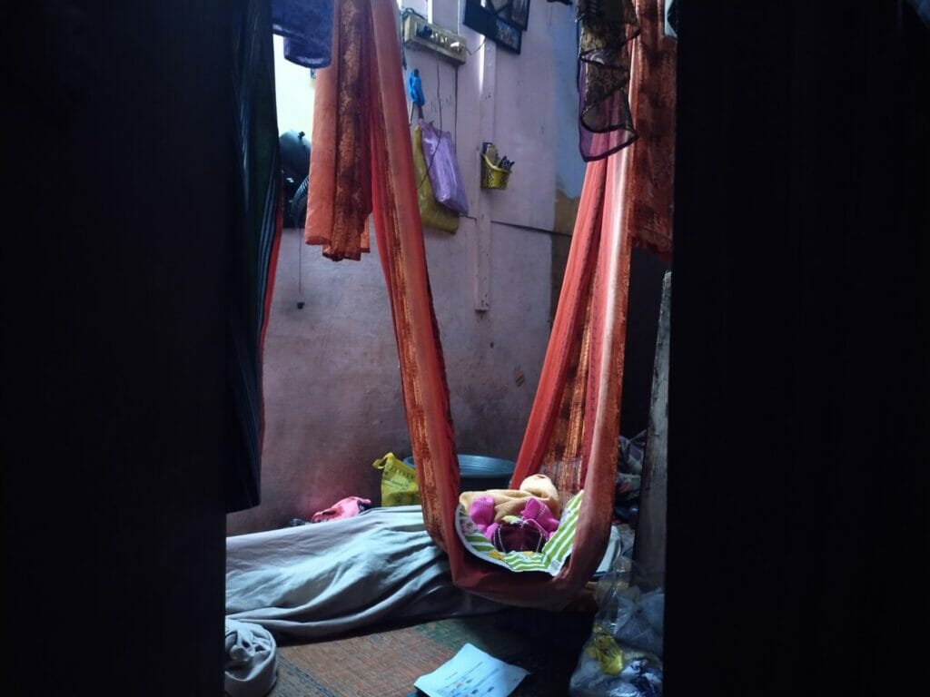 A child sleeping in a single room house in Kannappar Thidal