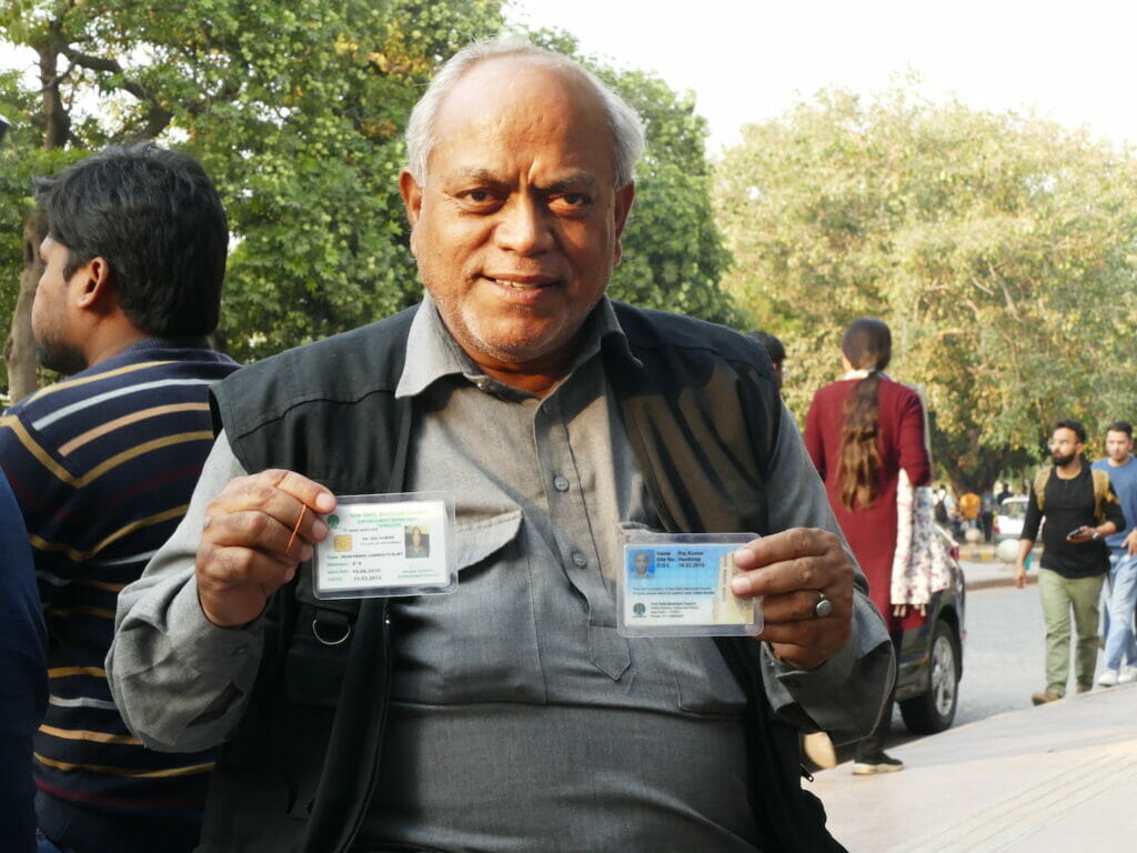 Street vendor Raj Kumar displays his ID