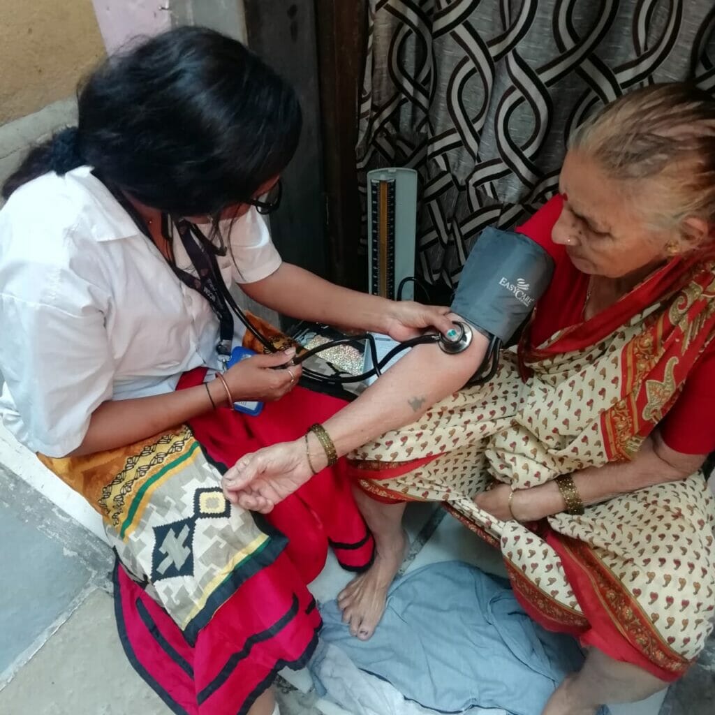 A doctor conducting medical check up of an old woman. 