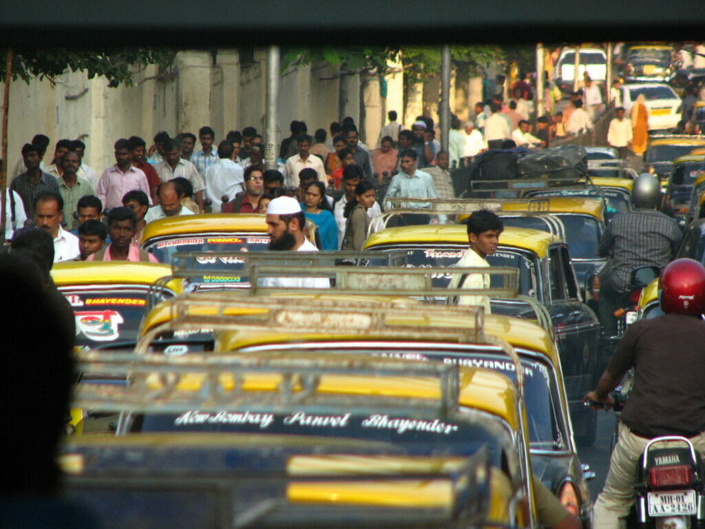 vehicles and passers-by on a Mumbai road