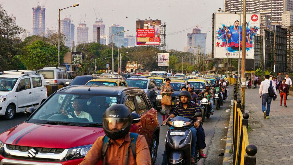 A packed road with cars, taxis and two wheelers showing traffic in Mumbai