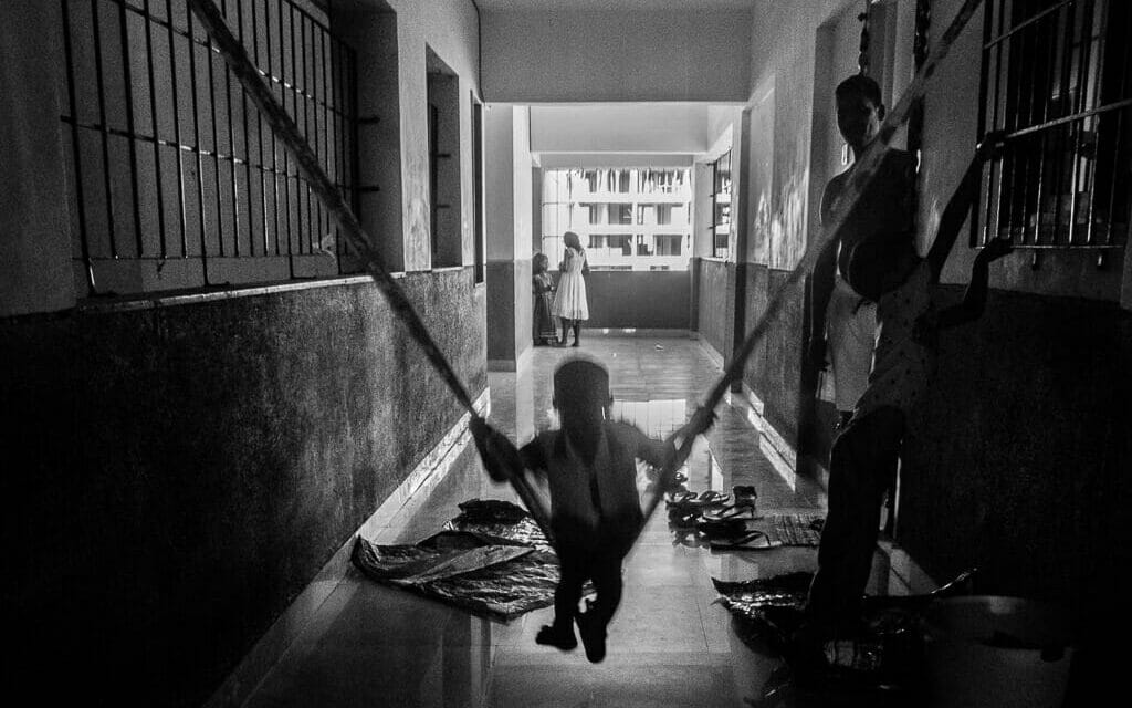 A child swinging in a corridor