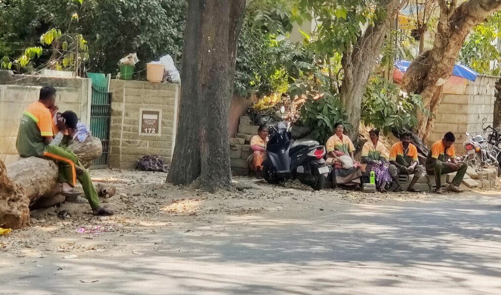 Pourakarmikas resting under the shade of trees