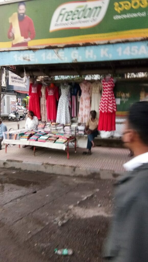 clothes being sold on the footpath