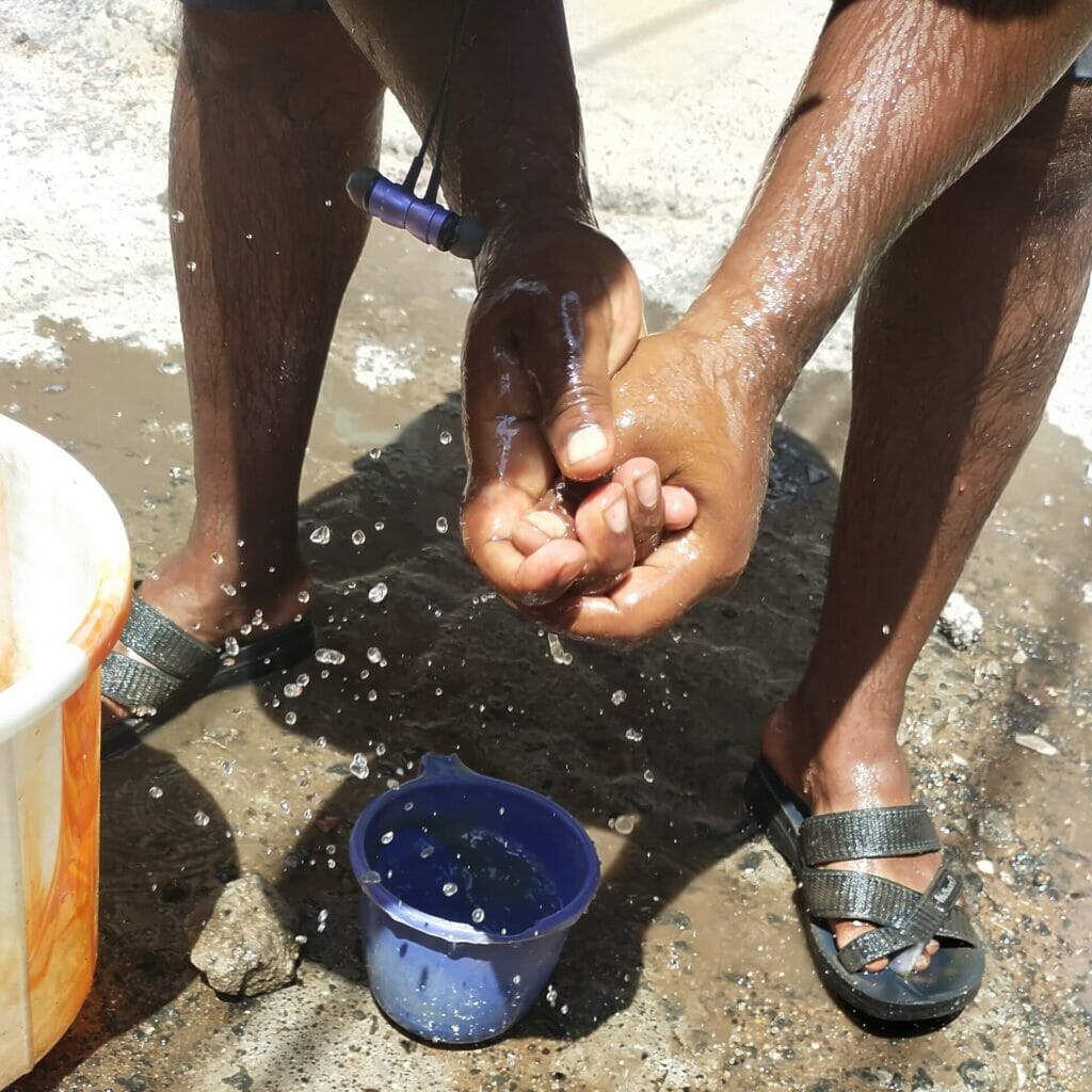 A manual worker in Chennai washing his hands