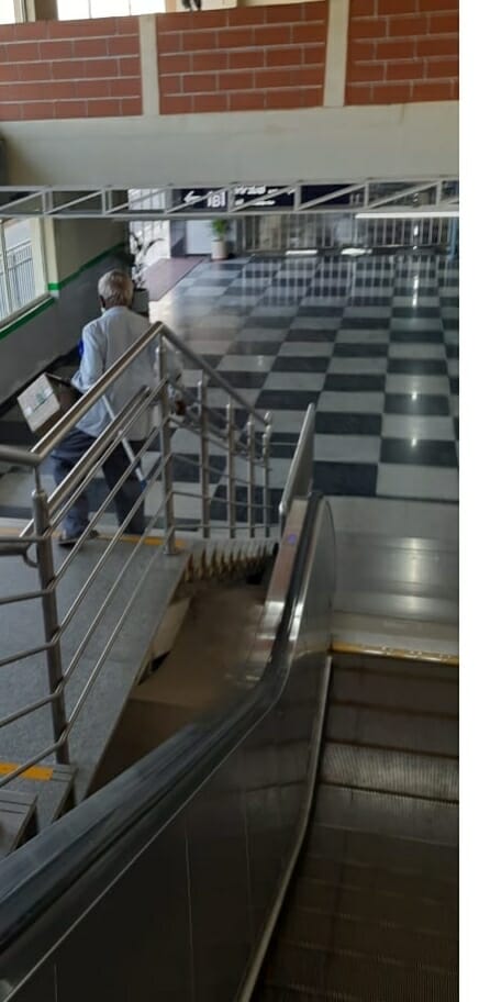 Senior citizens walking down the stairs in a metro station. 