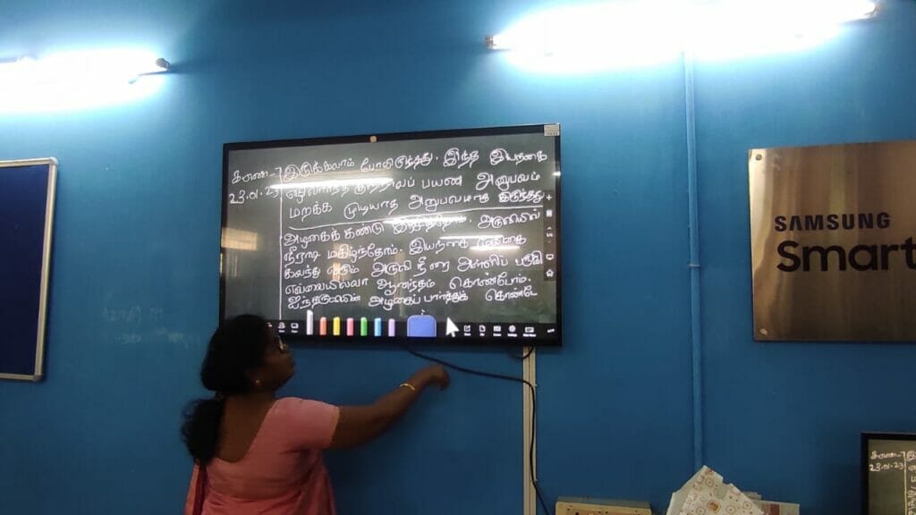 Teacher using smart board in Chennai Corporation School
