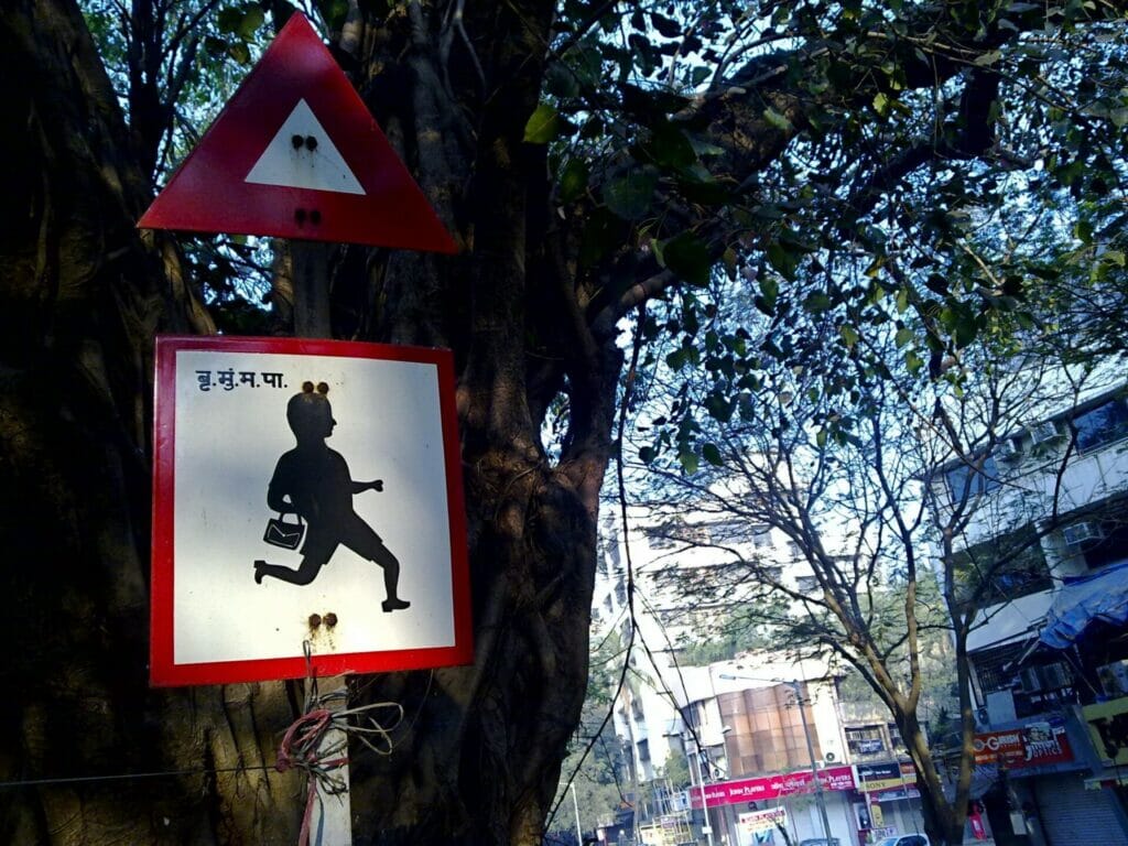 Road sign with a school kid
