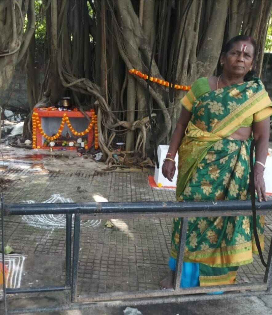 Munishwara Lakshmi standing in front of a Banyan tree. 