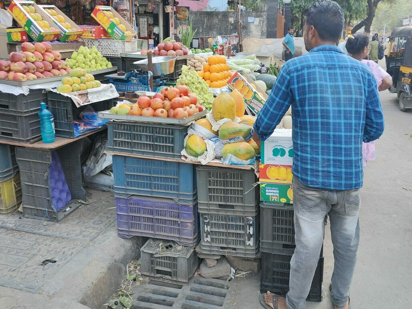 A fruit vendor selling fruits on the street