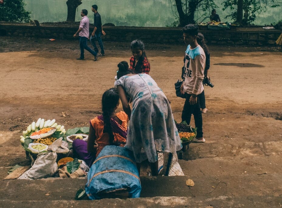 Warli women selling fruit in a park