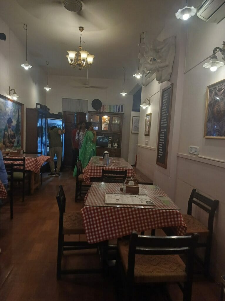 Tables at Bambai Nazariya cafe, in the background transgender staff 
