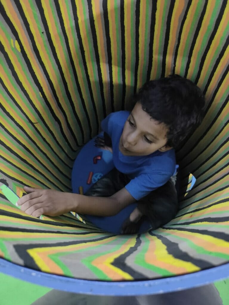 child playing in a cone