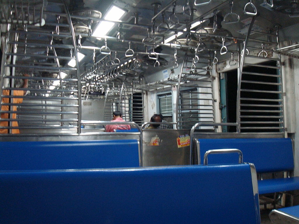 A rare empty coach of a Mumbai local train, at dawn.