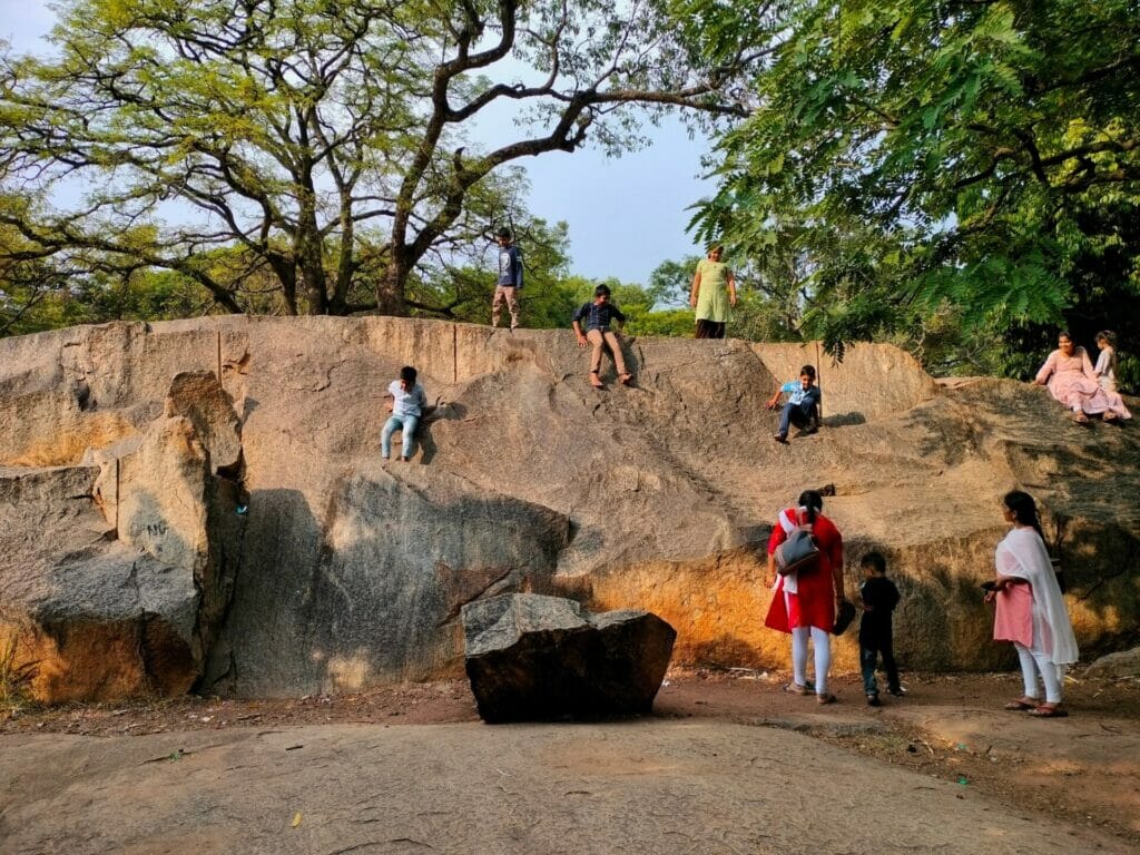 Children climbing the boulders in Cubbon Park.