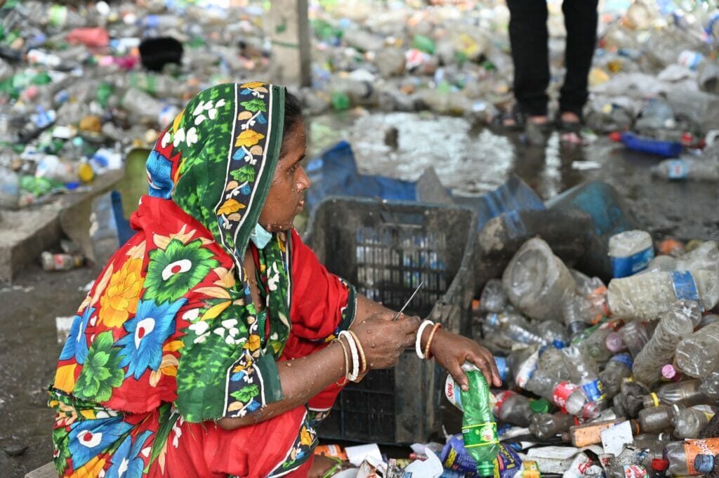 Wastepicker sorting plastic waste at a landfill