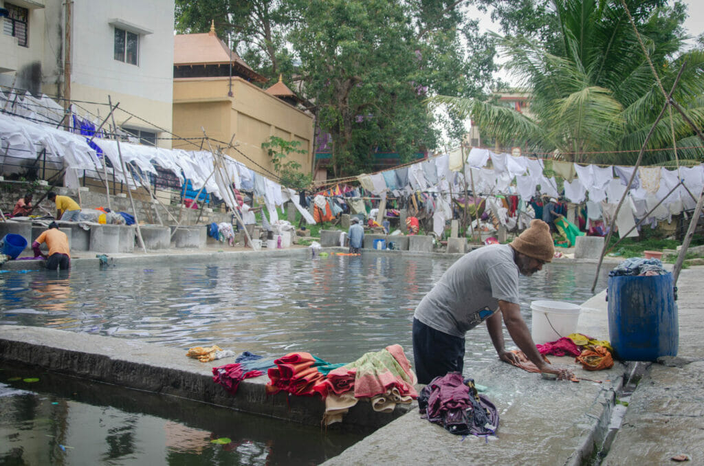 A dhobi washing clothes at the dhobi ghat