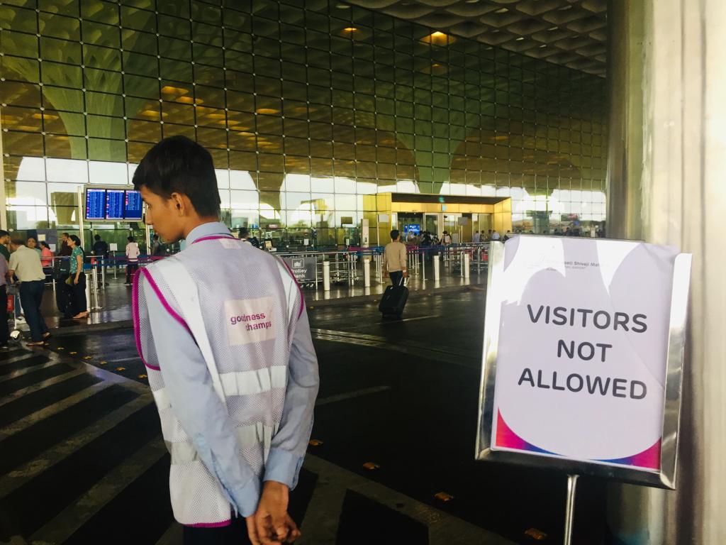 notice saying 'visitors not allowed' at the Mumbai airport. 