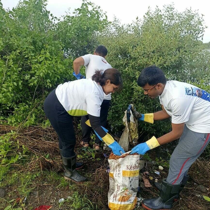 Volunteers collecting the waste at the mangrove forest during a clean-up drive