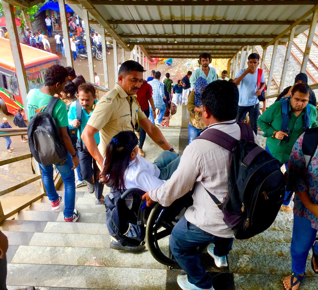 Railway police and other commuters helping Neetu get down from the footover bridge at Santacruz railway station.