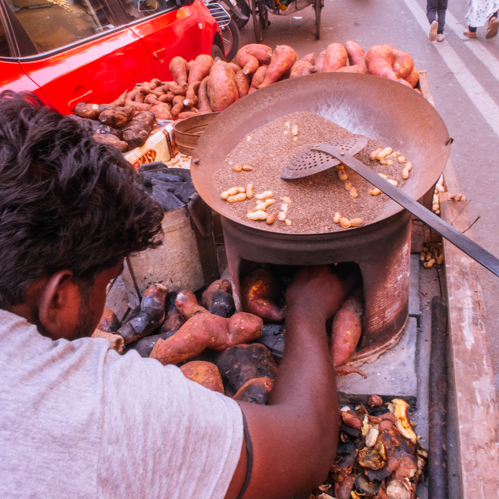 seller roasting sweet potato and ground nut using coal