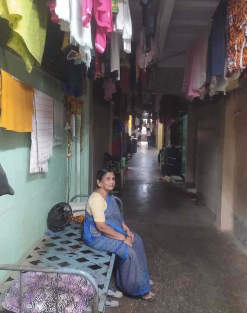 woman sitting in the corridor of bdd chawls