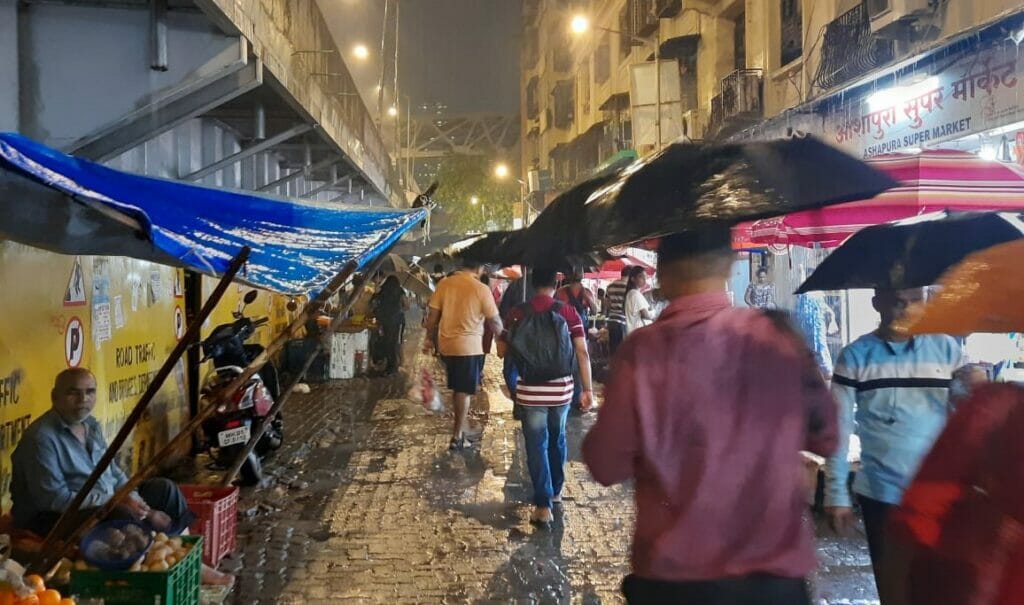 people walking on a crowded street in rains