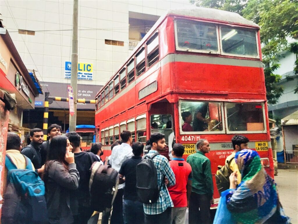 Passengers boarding the double-decker bus.