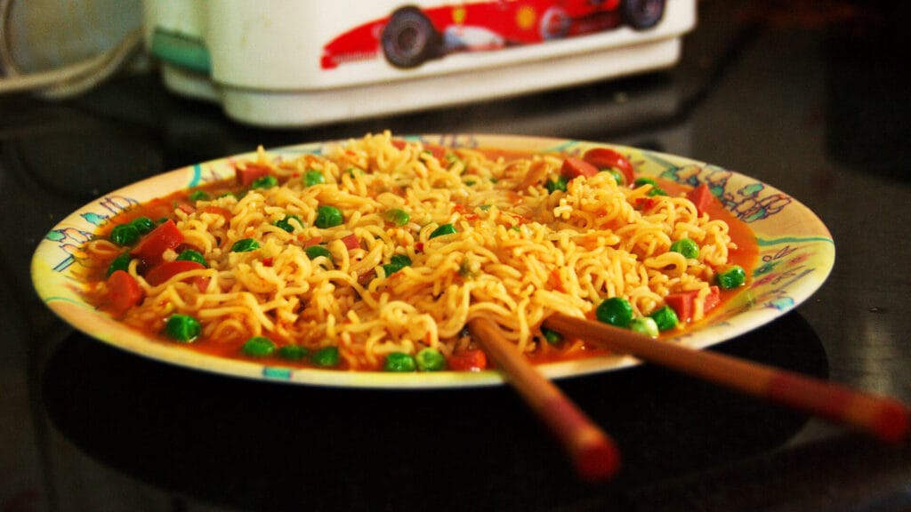 A plate of tempting cooked instant noodles, which falls under the category of ultraprocessed food
