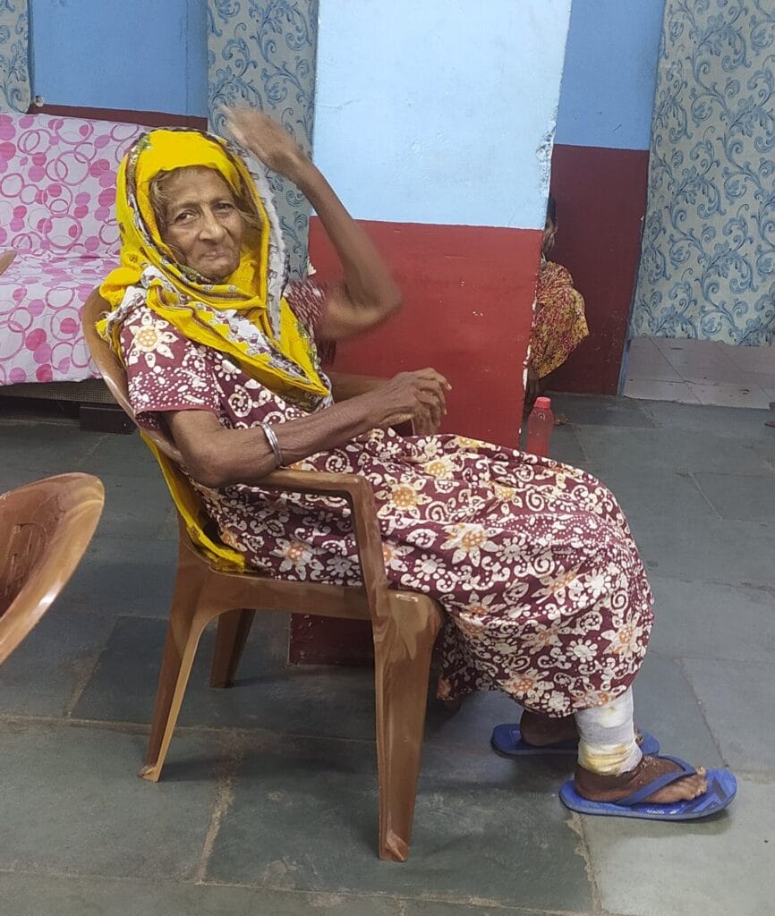 elderly woman at old age home with a bandaged wound on her foot