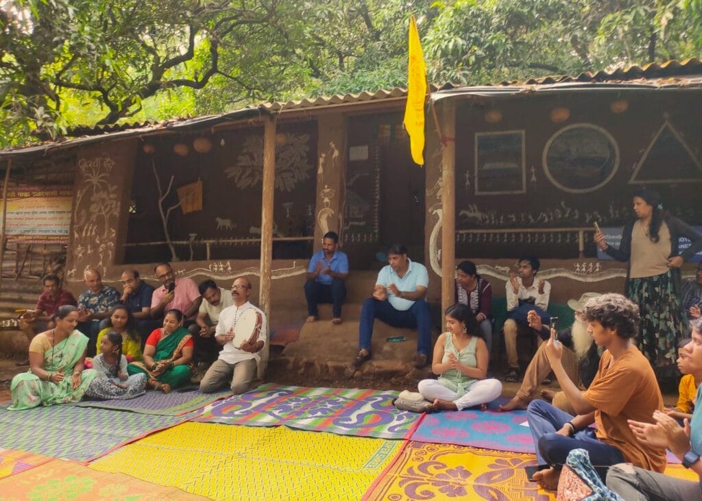 aarey movement supporters sitting together as prakash bhoir sings a song about aarey