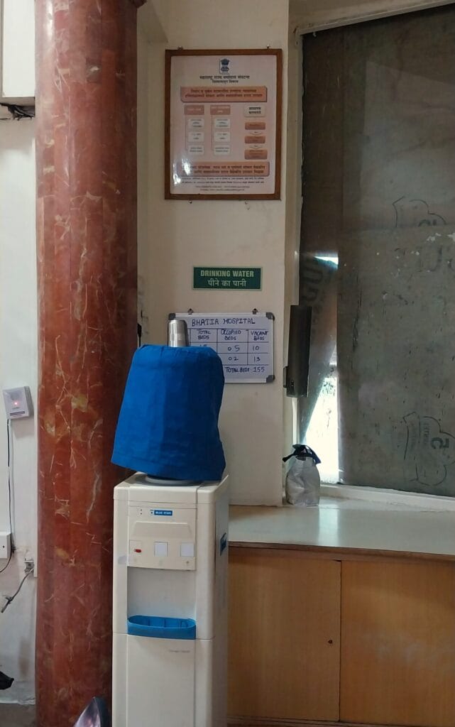 notice of vacant beds displyed behind water cooler in a charitable hospital 