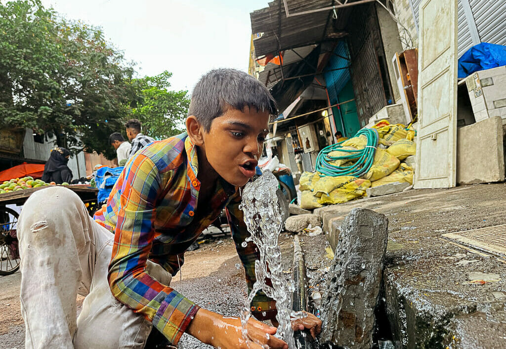Boy drinking water from tap