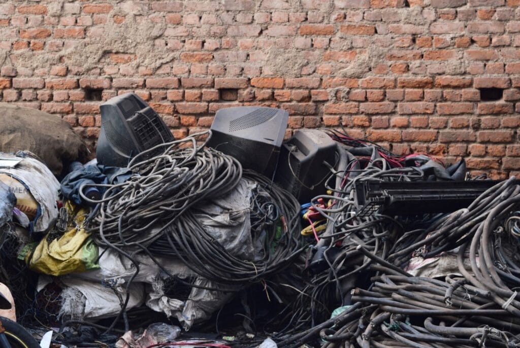 pile of wires and discarded computer parts - e-waste 