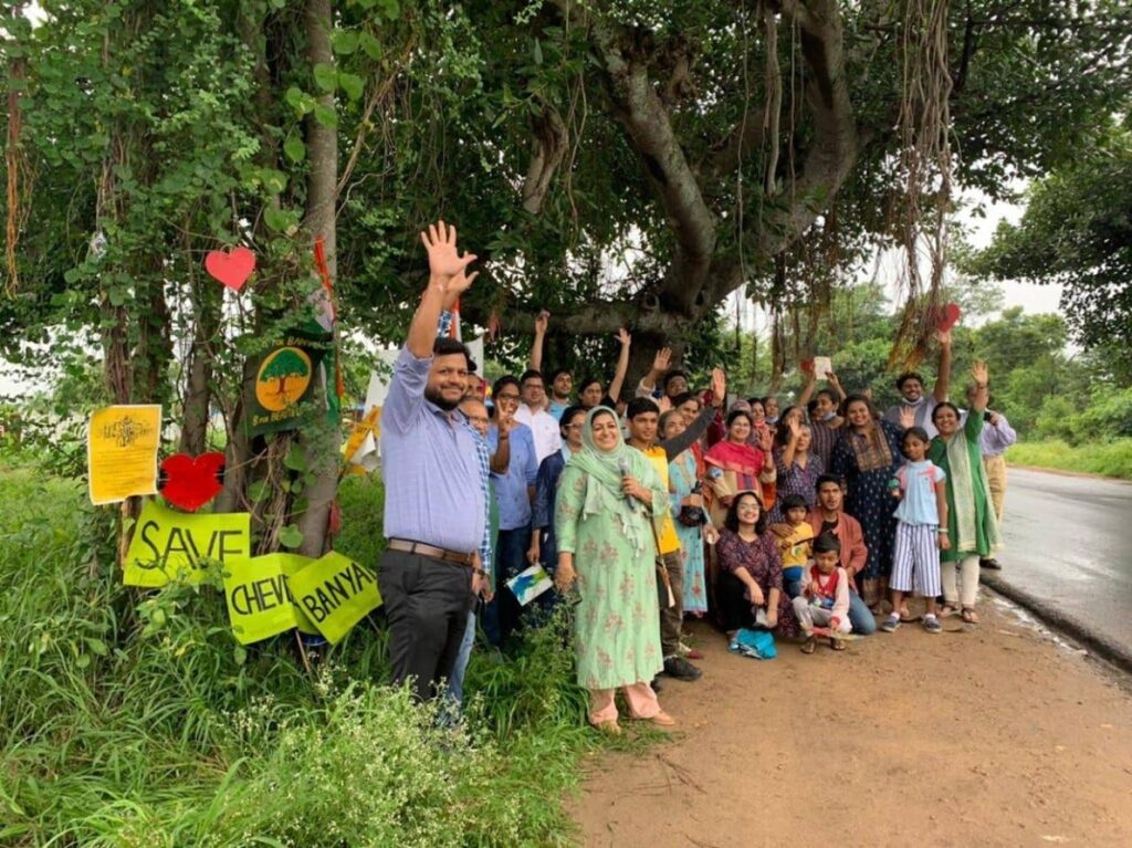 activists gathered under a banyan tree