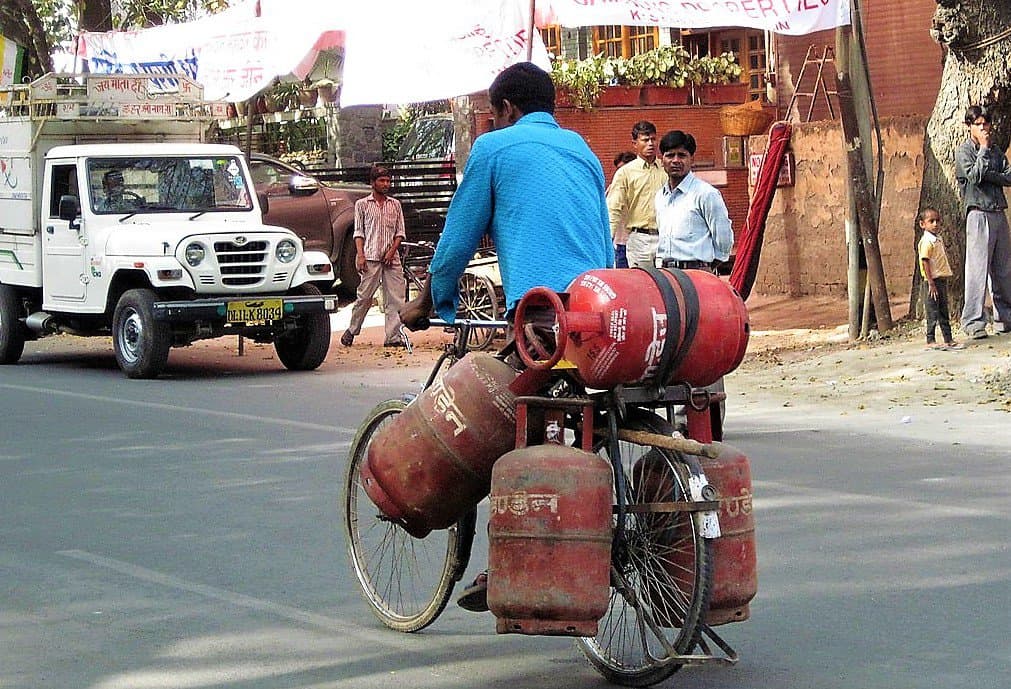 A man transporting LPG cylinders by bicycle