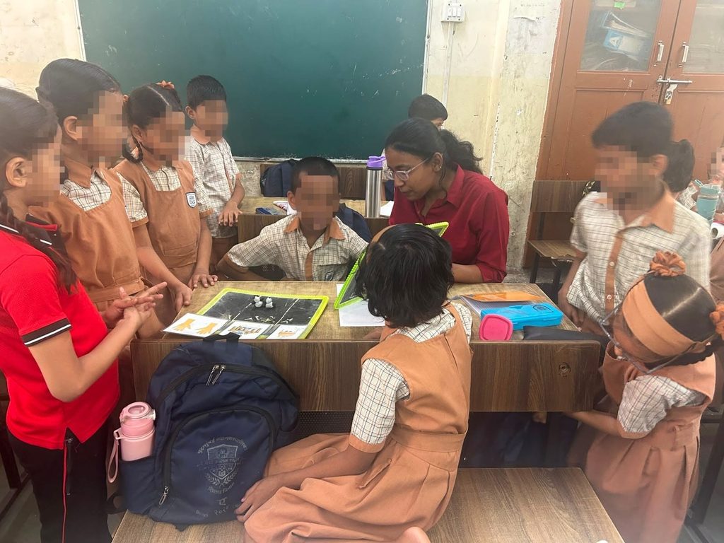 Children engage in activities with the teacher in a BMC school in Mumbai